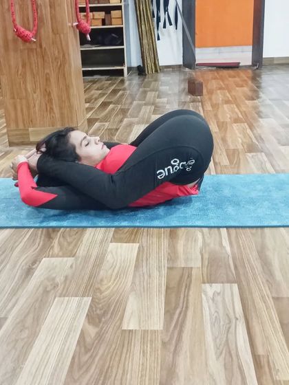 The final expression of Yoganidrasana, a pose that requires immense flexibility in the hips and spine.