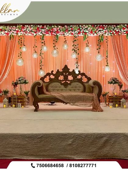 A grand reception stage with peach drapes and strobe lights. The elegant sofa and floral arrangements complete this dreamy and sophisticated setup.