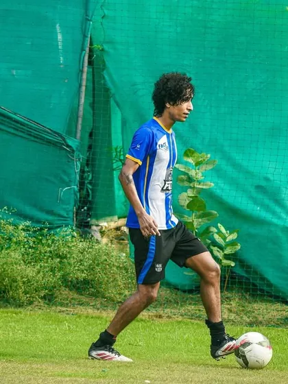 A player demonstrates focus and control, shielding the ball while planning his next move.