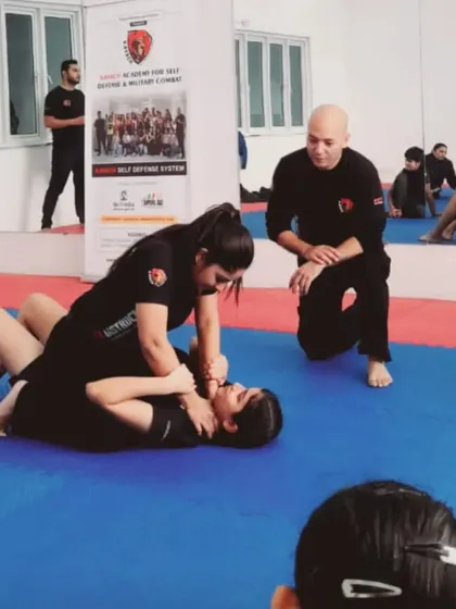 To be a true teacher, you must become the training itself. Here, I am supervising a ground control drill, ensuring techniques are applied correctly and safely.