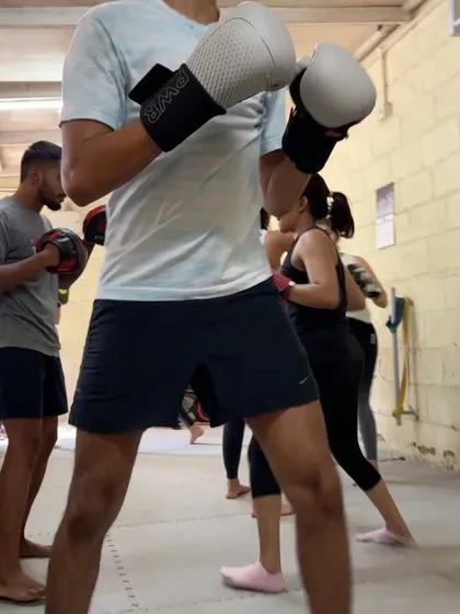 A member practicing his boxing form during a group class.