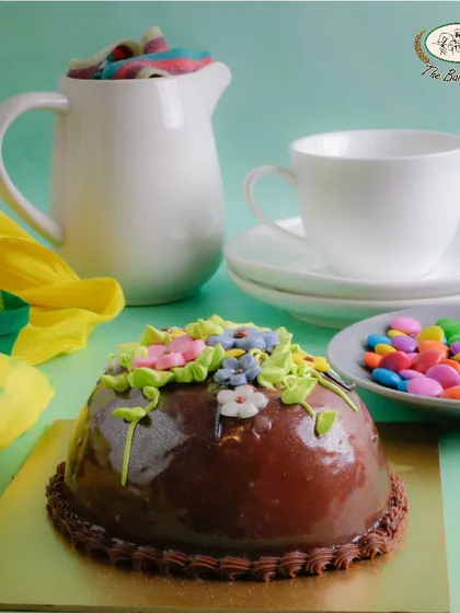 This Easter Egg Chocolate cake is shaped like half an egg and decorated with beautiful buttercream flowers.