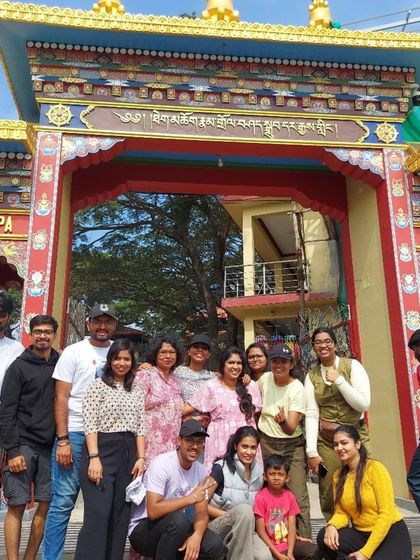 Our group at the entrance of the Namdroling Monastery, also known as the Golden Temple, in Coorg. A visit here adds a touch of spiritual calm to the trip.