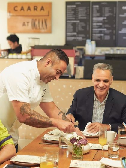 Chef Sid Sahrawat interacting with a guest during our collaborative dinner. We believe in creating a personal connection between the chefs and the diners.