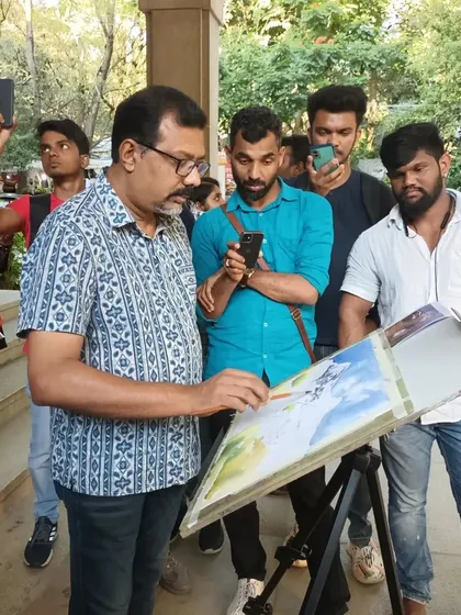 A closer look at the watercolor demo, where I am explaining my process to an engaged group of aspiring artists. I believe in making art accessible and enjoy sharing my knowledge with the community.