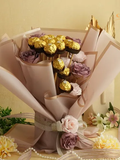 A classic Ferrero Rocher bouquet, artfully arranged with faux roses and pearls. This is a timeless gift that combines the luxury of chocolate with the beauty of a floral arrangement.
