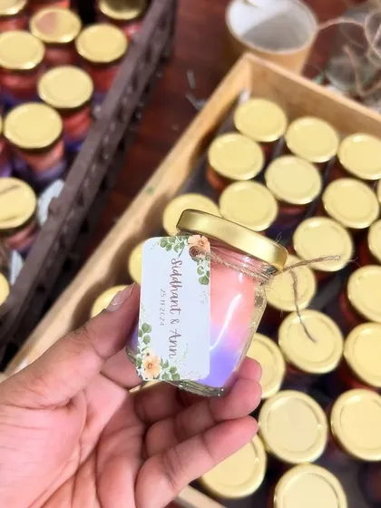 Our mini candle jars are perfect for budget-friendly bulk orders. We can create beautiful color combinations, like this pink and purple ombre effect, and add custom tags for any occasion.