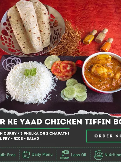 The 'Ghar Ke Yaad' Chicken Tiffin Box is pure comfort food. It comes with a hearty Chicken Curry, Dal Fry, rice, and salad, along with soft phulkas, designed to remind you of a home-cooked Sunday lunch.