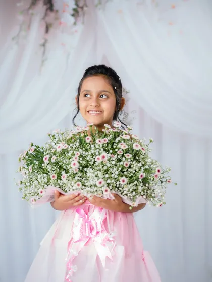 A bright, happy smile from this lovely girl during her floral-themed studio photoshoot.