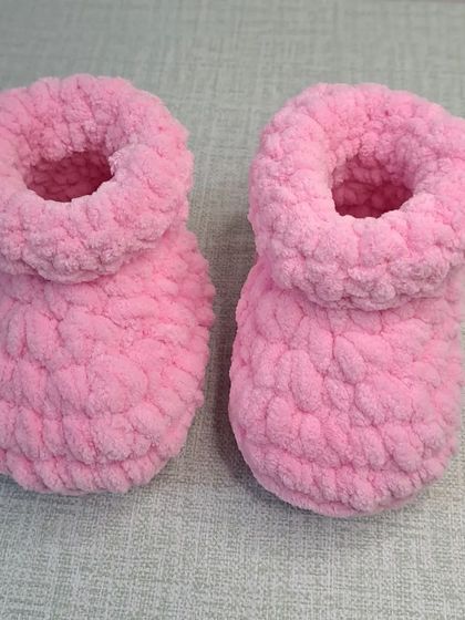 A top-down view of the plush pink chenille booties, showing their thick, soft texture.