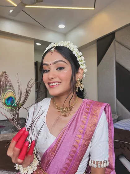 This creative Janmashtami look, inspired by Radha, shows my passion for thematic makeup. It features classic winged eyeliner, a traditional floral hairpiece, and artistic details that bring a vision to life.