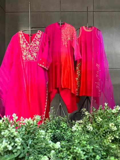 A collection of ombre-dyed kurtas in shades of pink and red, featuring delicate gold embroidery for a touch of sparkle.