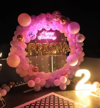 A beautiful terrace party for Prisha's 2nd birthday. The pink balloon ring with her name in foil letters and a neon sign looks stunning against the night sky.