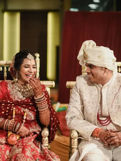 A candid moment of laughter between the bride and groom. Her makeup is designed to look beautiful and natural, even in these unposed, happy moments.