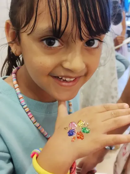This rainbow-colored flower glitter tattoo is a handful of happiness. The bright, distinct colors make the design really stand out and bring a big smile.