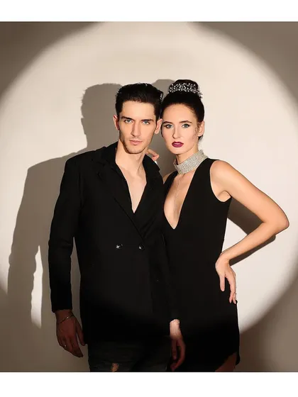 A variation of the couple's spotlight shoot, with a more direct and confrontational pose. This is perfect for a luxury brand campaign or a fashion editorial.