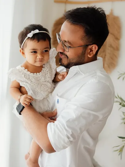 A quiet moment between a father and his one-year-old daughter. These simple, heartfelt portraits are often the ones that parents treasure the most.