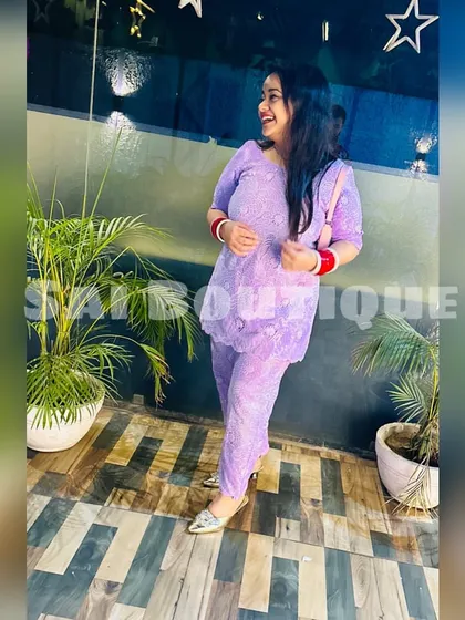 A happy client in a lavender chikankari suit. It's a perfect, breezy outfit for a summer day.