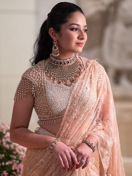 A close-up of the engagement glam, with a chic ponytail and statement jewellery.