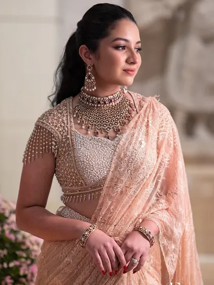 A close-up of the engagement glam, with a chic ponytail and statement jewellery.