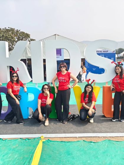 The Tiny Tribes team posing with the giant "KIDS" sign at a children's festival. We are proud to be a part of events that celebrate childhood, creativity, and play.
