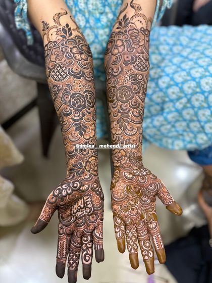 A classic bridal design featuring roses and intricate fill patterns, extending all the way up the arms.