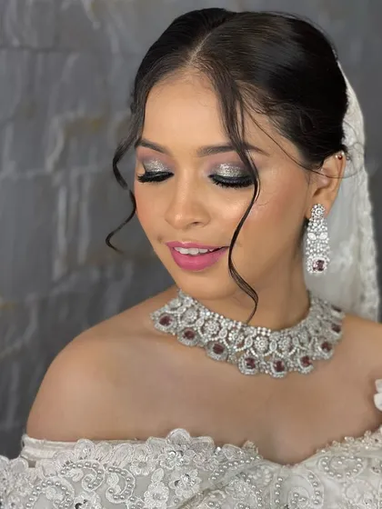 This client looks absolutely gorgeous for her reception or cocktail party. She rented this stunning silver-toned choker with ruby-red stones, which adds a perfect pop of color to her elegant white off-shoulder gown.