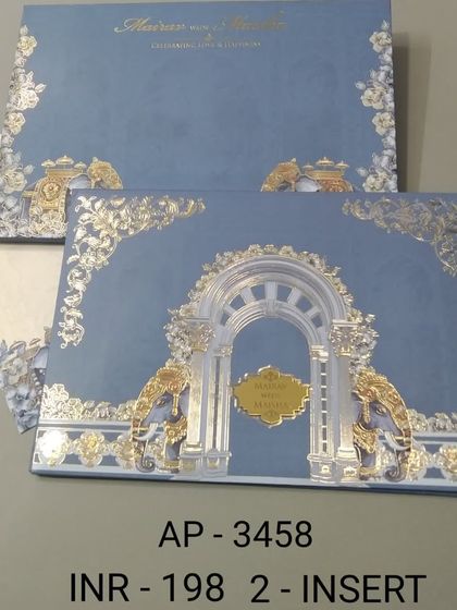 A stately blue invitation featuring a grand palace archway and elephants, all accented with intricate gold foil. This card is an affordable yet luxurious option for a royal-themed wedding.
