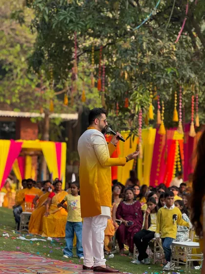 Addressing the guests at an outdoor Haldi function. I make sure everyone knows the plan for the day's festivities and games.