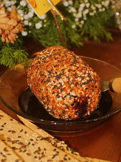 A bold Wasabi Cheese dome, drizzled with a dark sauce and coated in sesame seeds. This appetizer offers a spicy kick and is perfect for an adventurous palate.