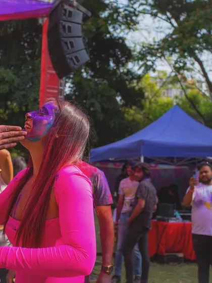 A moment of pure joy as a guest gets colors applied during the Colour Splash event. It's all about the spirit of Holi.