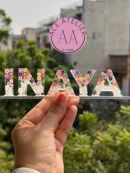 Another beautiful floral name stand, this one for 'Inaya'. The clear resin allows the colorful flowers to stand out, making it a cheerful and personal decor piece.
