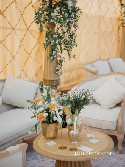 A close-up of a cozy lounge area. The simple floral arrangement on the coffee table adds a touch of freshness and elegance to the comfortable seating space.