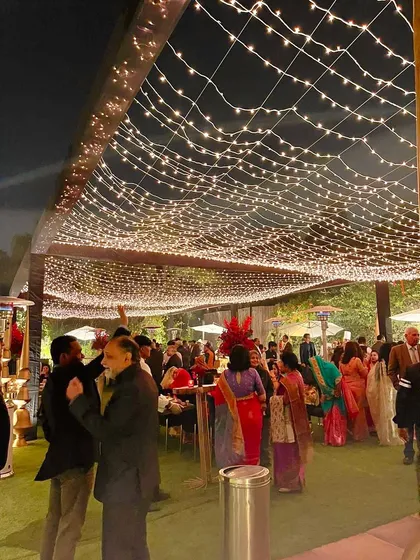 A sky of fairy lights creates a magical canopy for guests to mingle and dance. This is how I turn our open lawns into an enchanting space for receptions and sangeet nights.