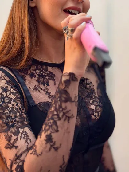 A close-up of the delicate custom black lace outfit worn by Dhvani Bhanushali. This highlights the texture and detail that might not be visible from the audience.