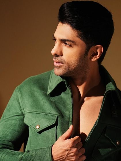 Taha Shah in our green tailored jacket. The rich color and structured silhouette create a powerful look that is both modern and timeless.