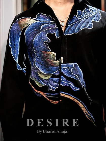 A detail shot of the abstract wave shirt, showcasing the hand-painted design and the subtle shimmer of the fabric.