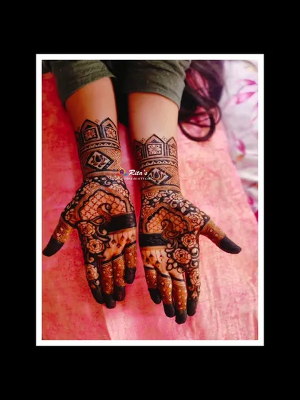 The final design for the Goldhana ceremony, with beautiful peacocks on the palms and intricate patterns on the arms.