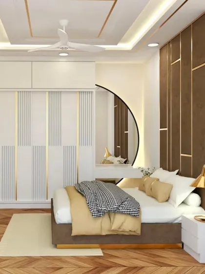 An elegant bedroom with a herringbone wood floor and a striking accent wall. The wardrobe features white and gold details, adding to the room's luxurious feel.