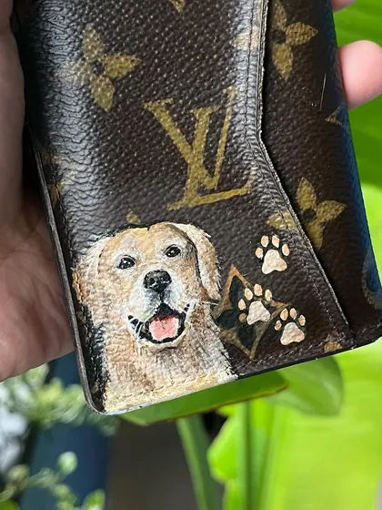 A close-up of the Golden Retriever portrait on another custom LV card holder, complete with little paw prints.