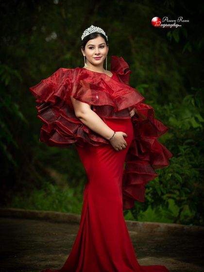 Feel like a queen in our red mermaid-style Ruth gown. The dramatic organza ruffles and tiara accessory create a look that is both powerful and regal.