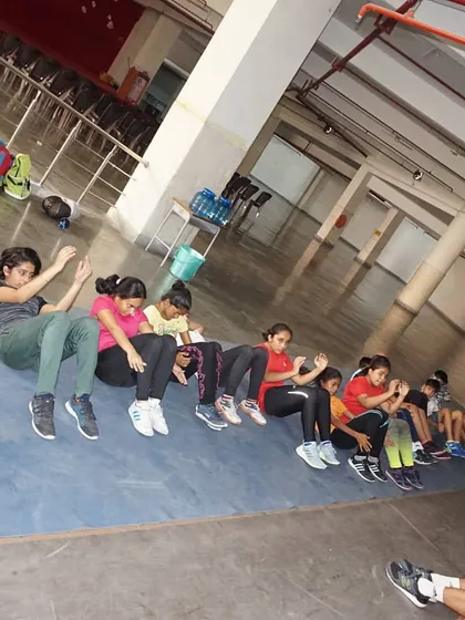 Our female fencers doing sit-ups together. We encourage our athletes to motivate and push each other to be their best.