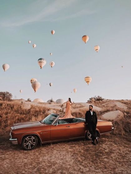 This couple looks like they are on a movie set. The combination of the vintage car, the incredible landscape, and my flowing gown makes for an unforgettable pre-wedding picture.