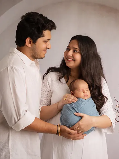 New parents sharing a look of love and wonder as they hold their baby. My studio sessions are designed to be comfortable, allowing these natural, heartfelt moments to unfold.