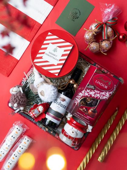 The 'Santa's Sweet Retreat' hamper packed in a box with a clear lid, showing off all the festive goodies inside.