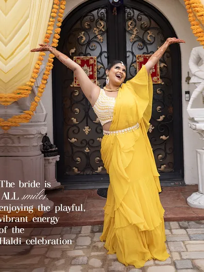 The bride is all smiles, enjoying the playful, vibrant energy of her Haldi celebration. Her sunshine-yellow saree radiates happiness.