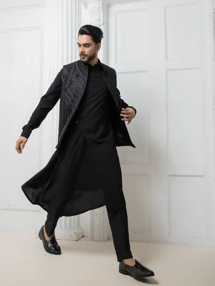 I design for movement and impact. This black Indo-western set features a hand embroidered jacket over a fluid, draped kurta, offering a modern and dynamic option for a sangeet or reception.