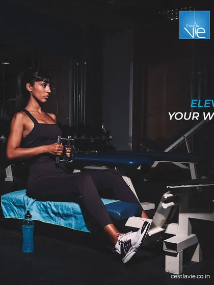 Elevate your workout with focused, effective movements. This image shows a member using a seated row machine, demonstrating our range of equipment for targeting specific muscle groups.