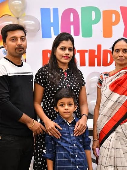 Posing for a family photo in front of our birthday banner. We love being a part of your special day and helping you capture these happy memories.