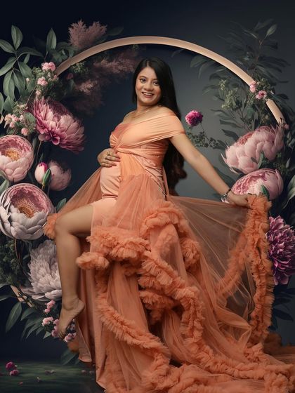 Surrounded by a halo of blooming peonies, this portrait in a peach ruffled gown is pure art. It captures a moment of joyful serenity and the beauty of a life in bloom.